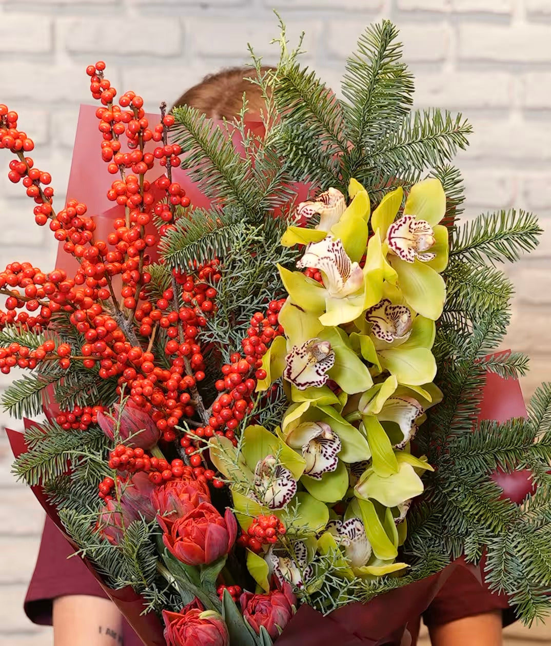 №103 Winter Elegance Bouquet: Orchids, Tulips, Berries, and Evergreen Bliss